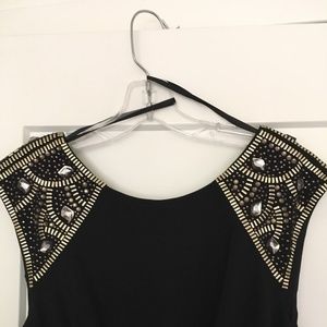 Long black dress w/embellishments on the shoulder